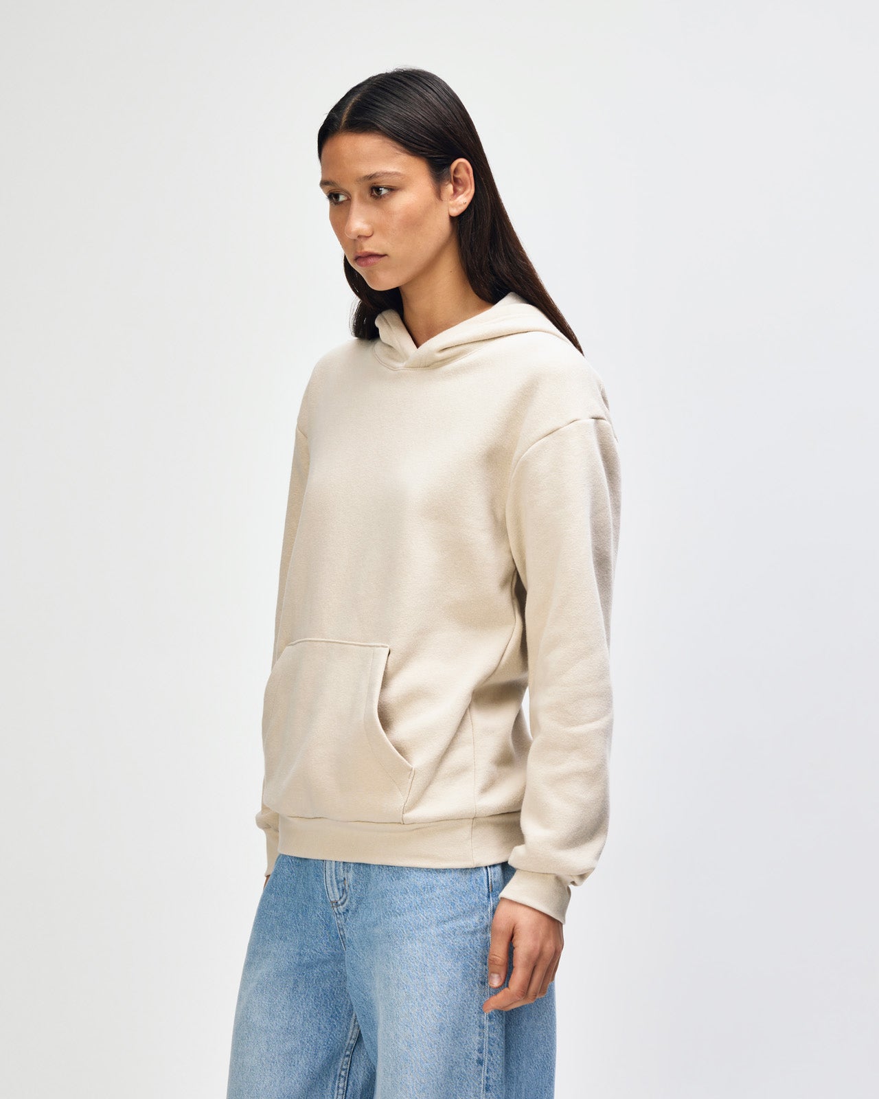 Female model wearing a Reflex Unisex Hooded Sweatshirt (front pose) -bone