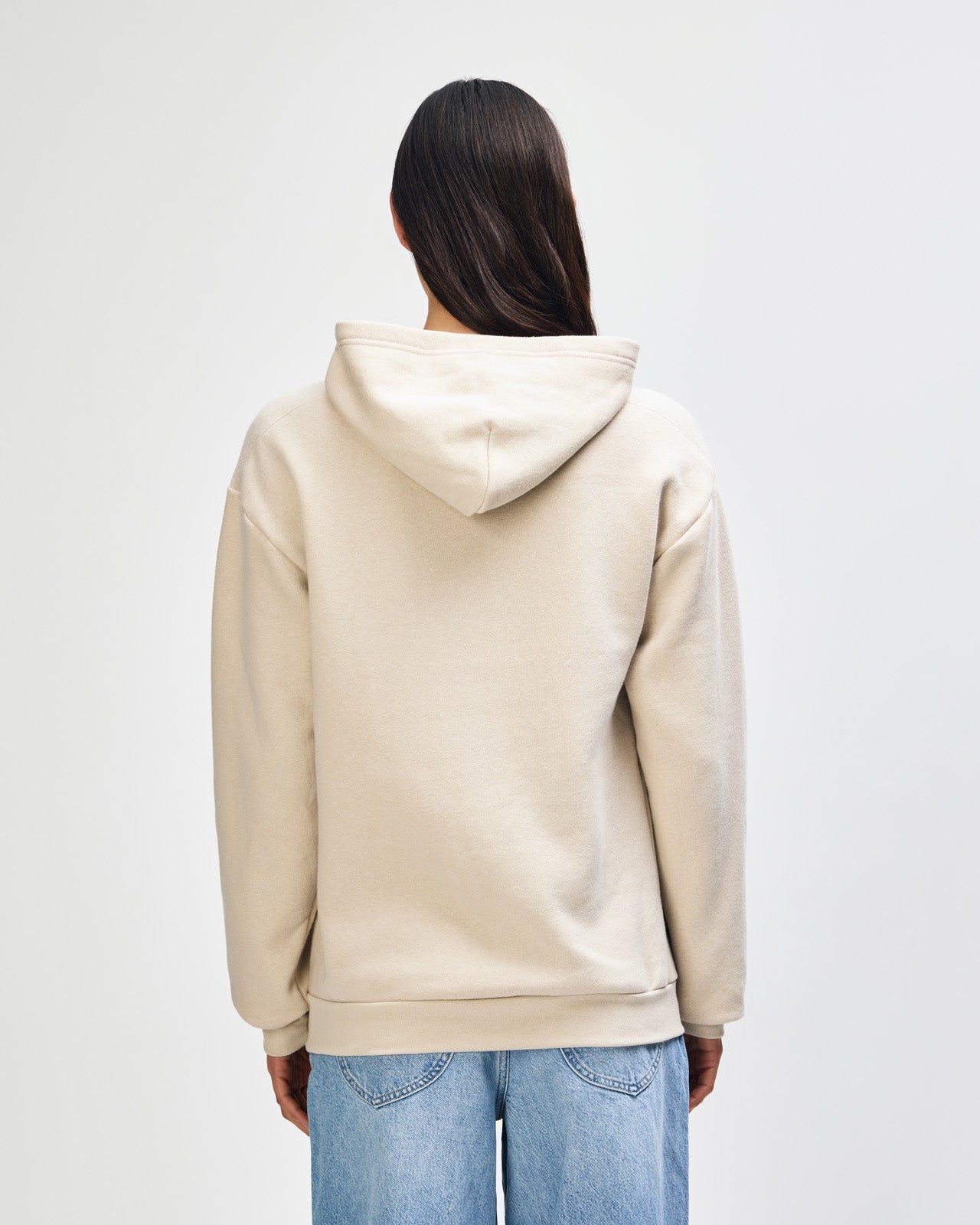 Female model wearing a Reflex Unisex Hooded Sweatshirt (back pose) -bone
