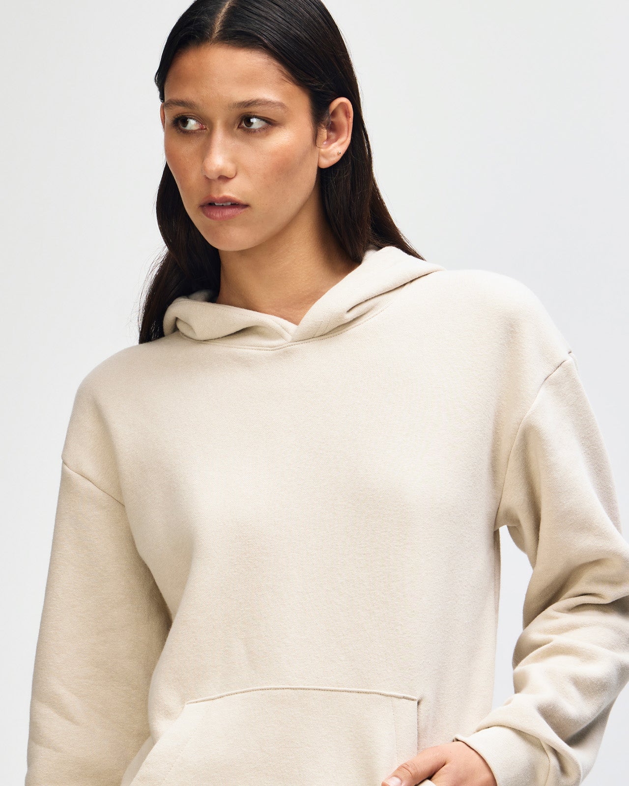 Female model wearing a Reflex Unisex Hooded Sweatshirt (front pose) -bone