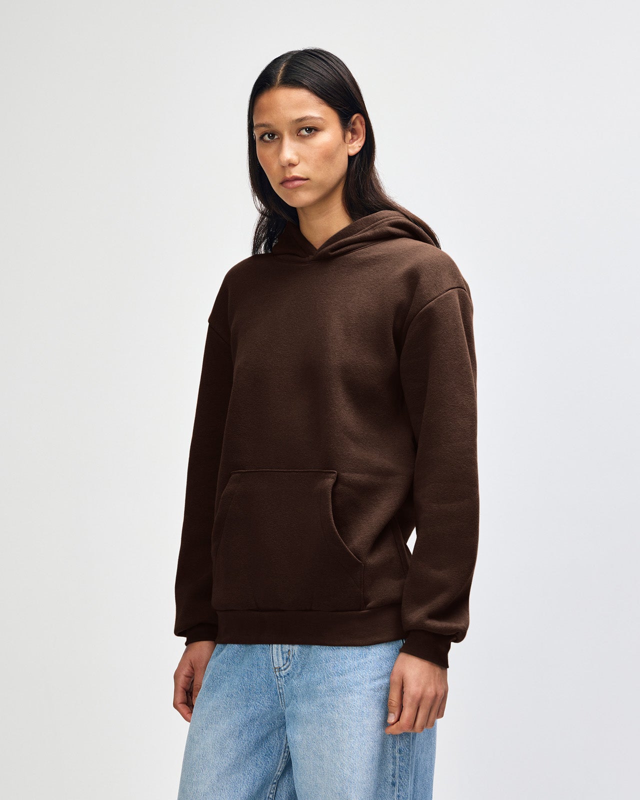 Female model wearing a Reflex Unisex Hooded Sweatshirt (front pose) -Brown