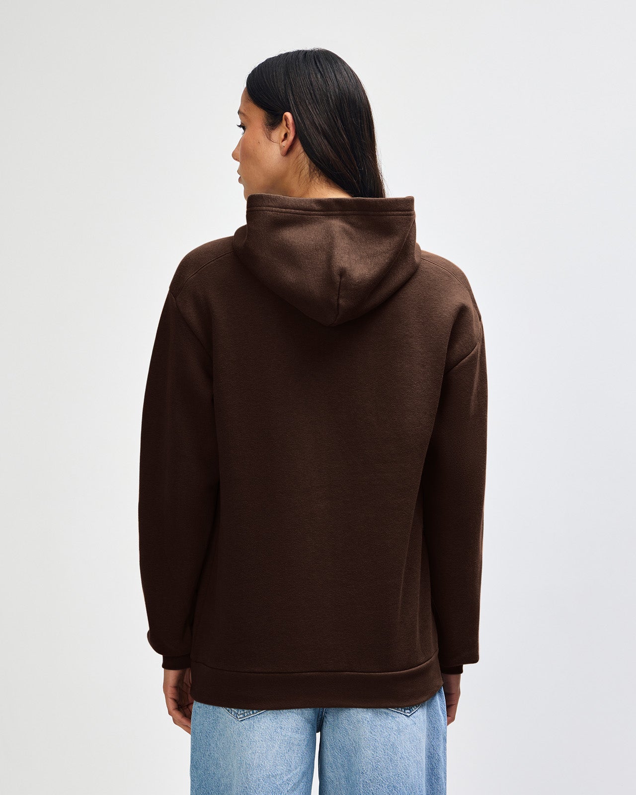 Female model wearing a Reflex Unisex Hooded Sweatshirt (back pose) -Brown