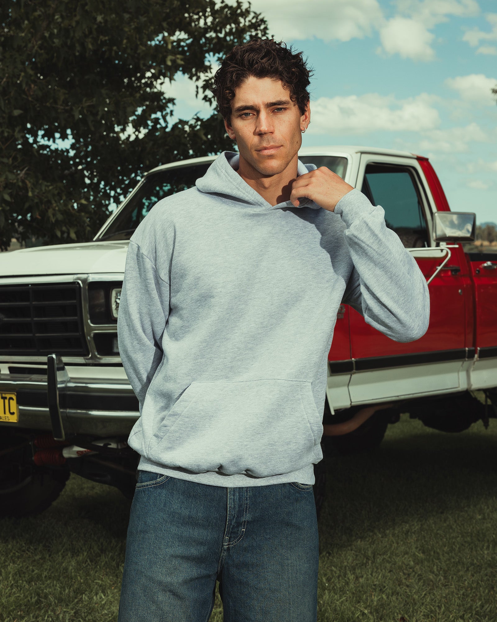 Male model wearing a Reflex Unisex Hooded Sweatshirt (front pose) -heather grey