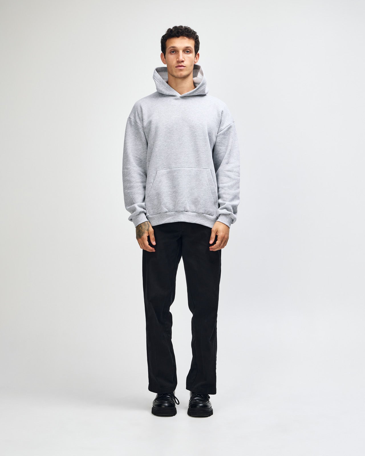 Male model wearing a Reflex Unisex Hooded Sweatshirt (front pose) -heather grey