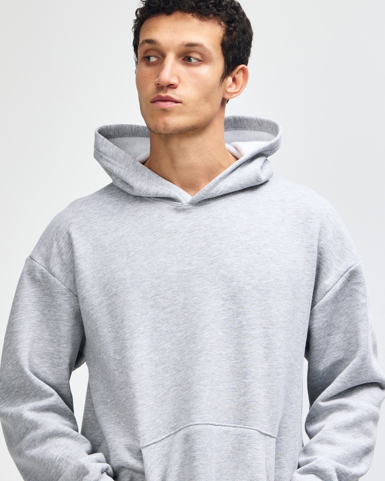 Male model wearing a Reflex Unisex Hooded Sweatshirt (front pose) -heather grey