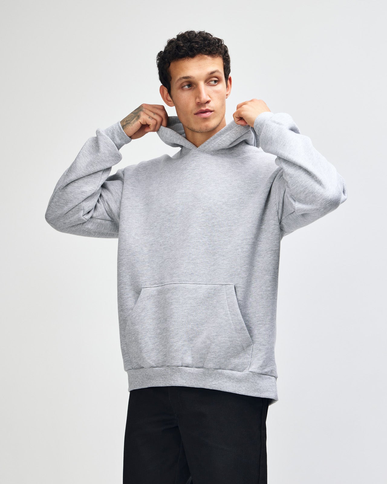 Male model wearing a Reflex Unisex Hooded Sweatshirt (front pose) -heather grey