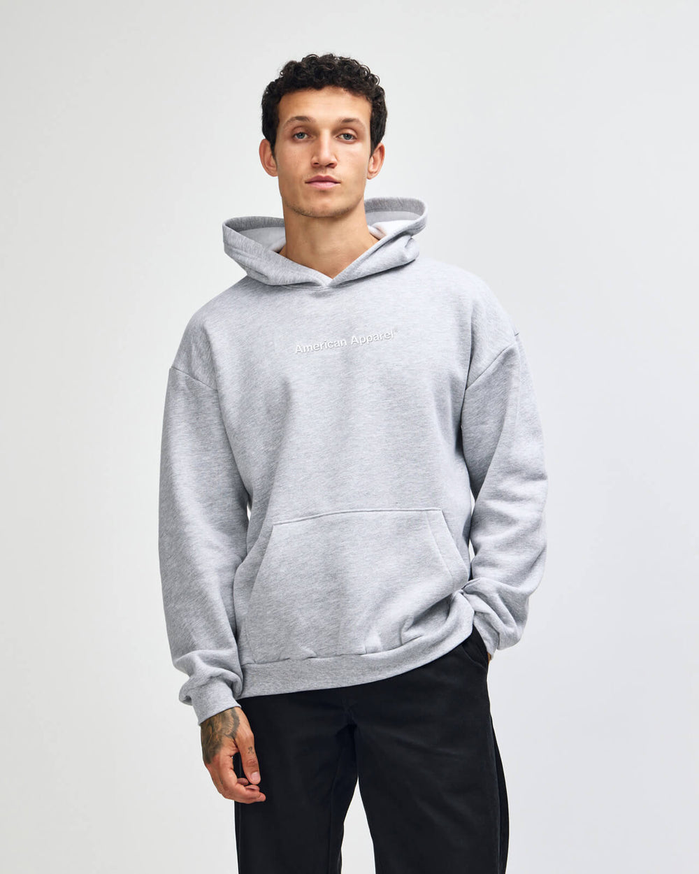next image of Pullover Hoodie  Tracksuit Set - Embroidered Logo - Heather Grey : Man wearing a gray hoodie on a plain background -Heather Grey