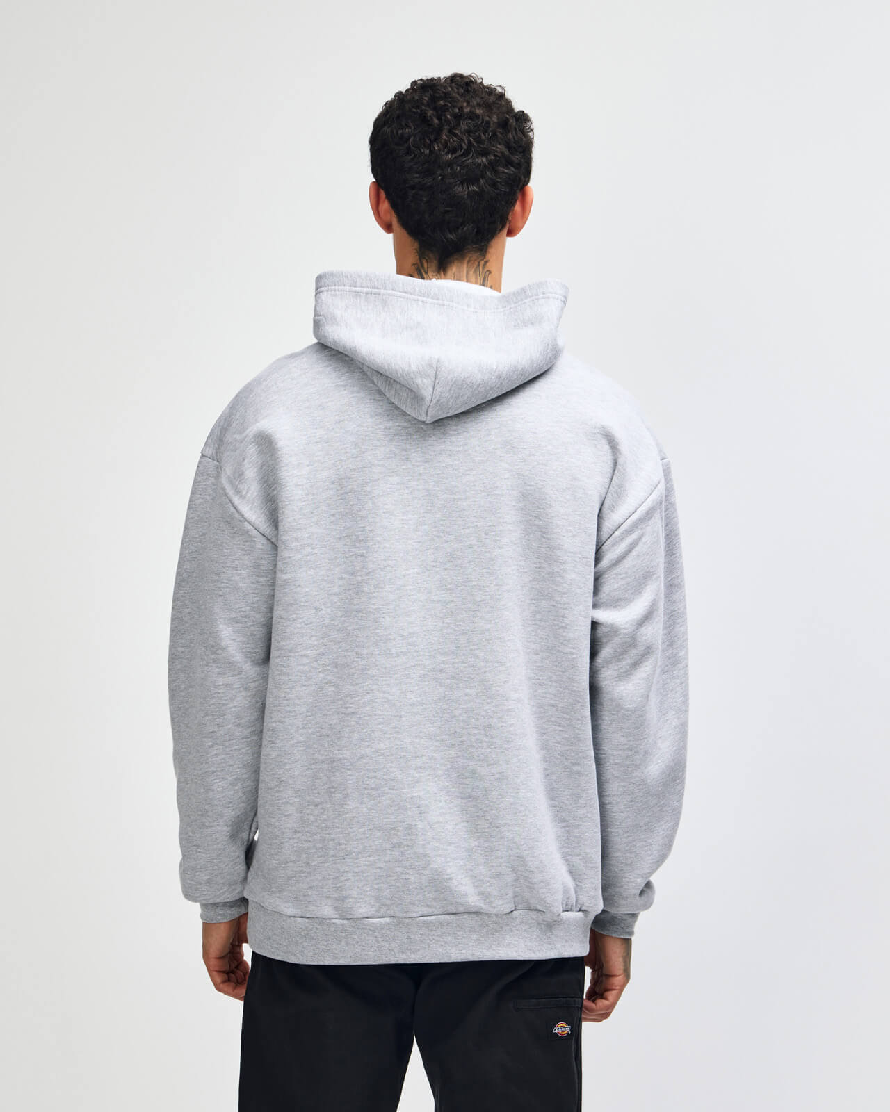 Person wearing a gray hoodie from behind on a white background -Heather Grey