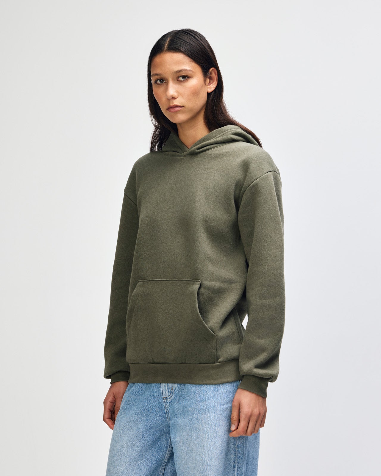 Female model wearing a Reflex Unisex Hooded Sweatshirt (front pose) -lieutenant