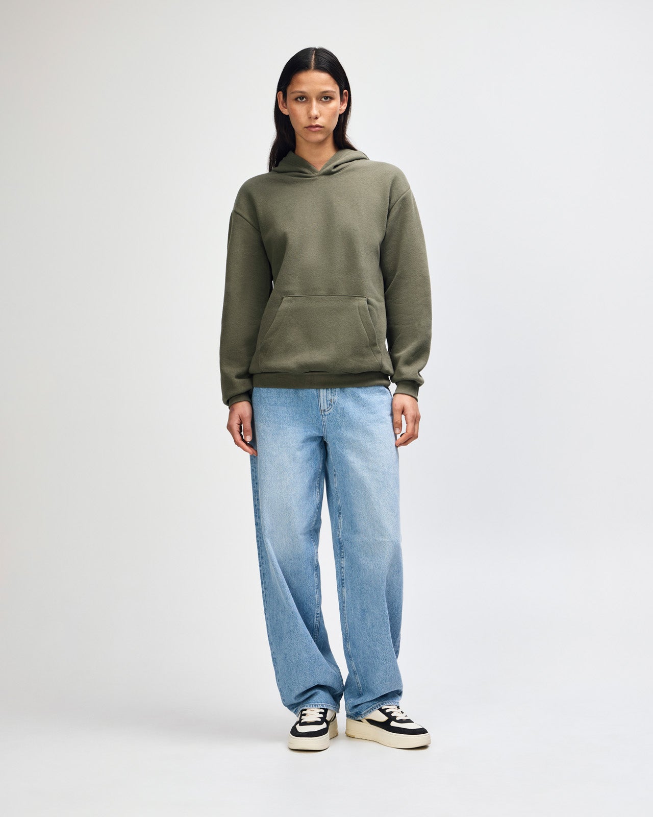 Female model wearing a Reflex Unisex Hooded Sweatshirt (front pose) -lieutenant