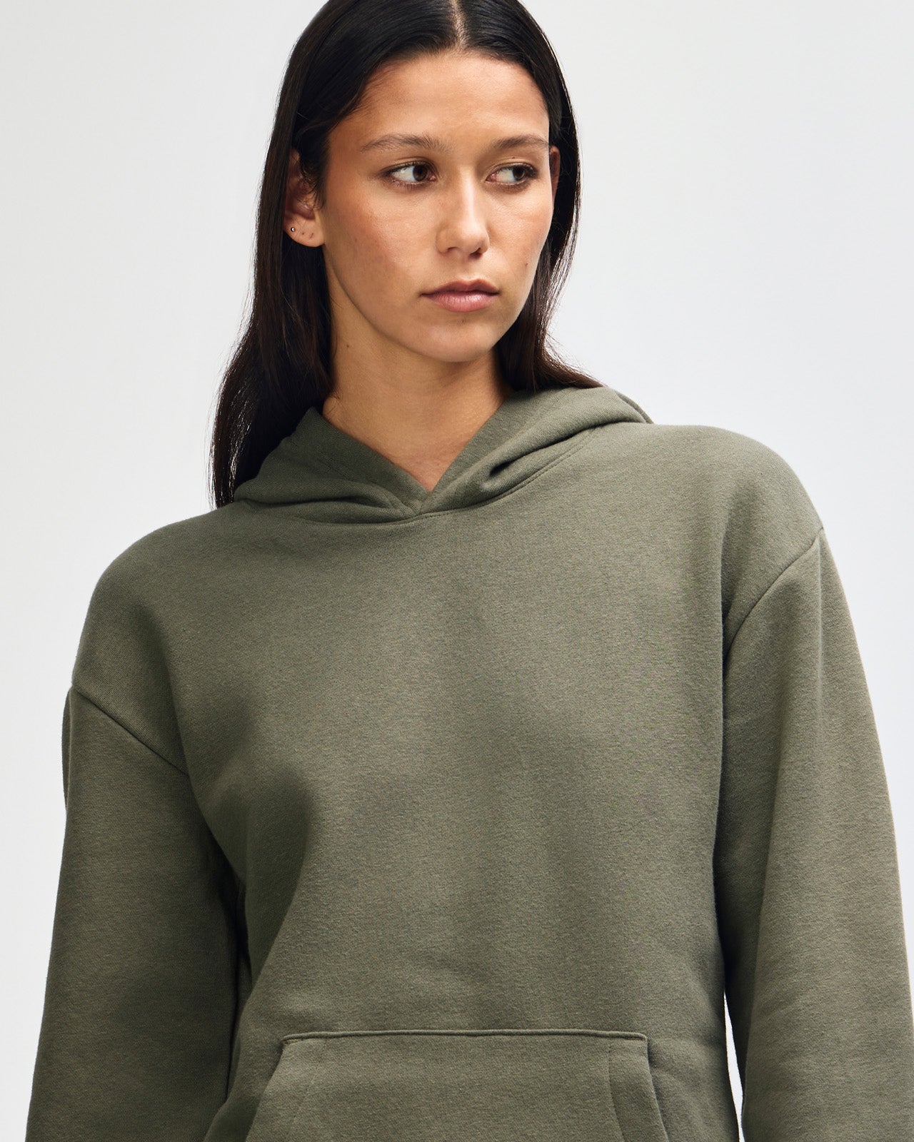 Female model wearing a Reflex Unisex Hooded Sweatshirt (front pose) -lieutenant