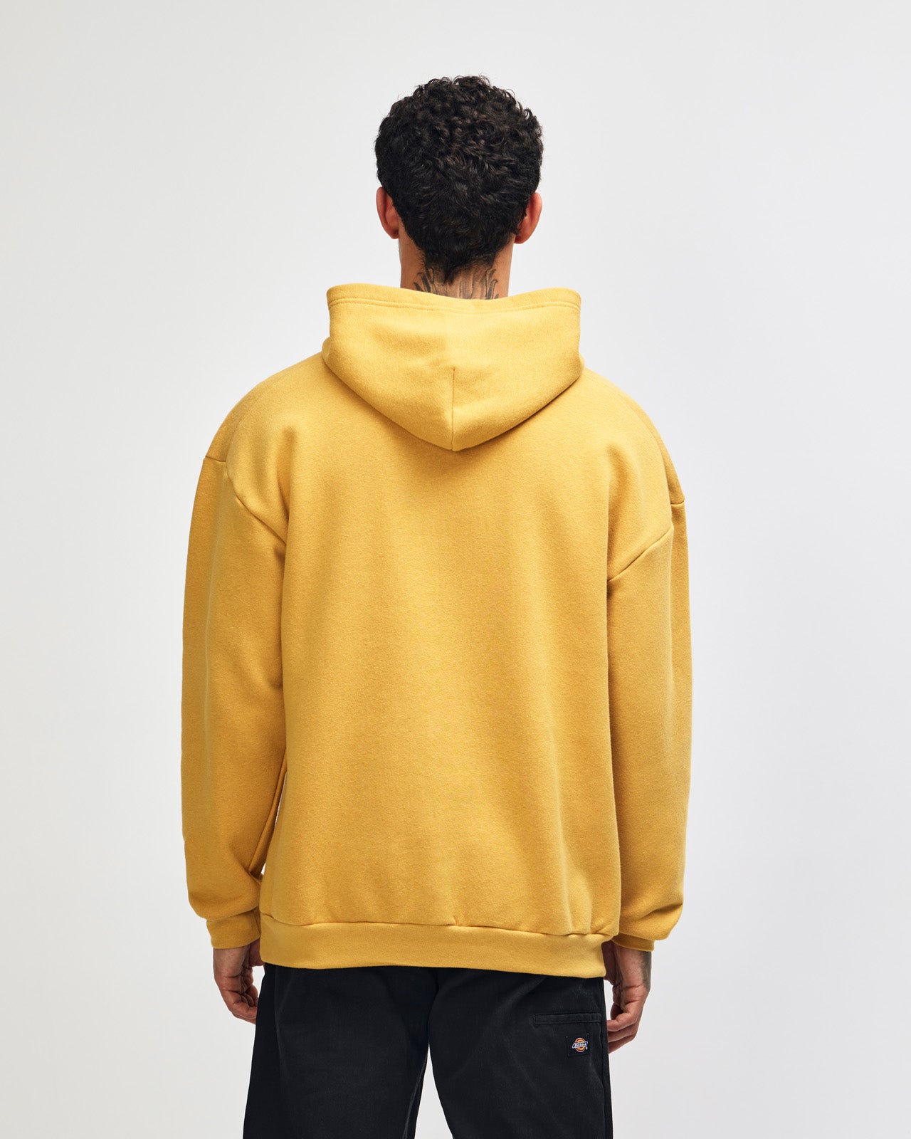 Male model wearing a Reflex Unisex Hooded Sweatshirt (back pose) -mustard