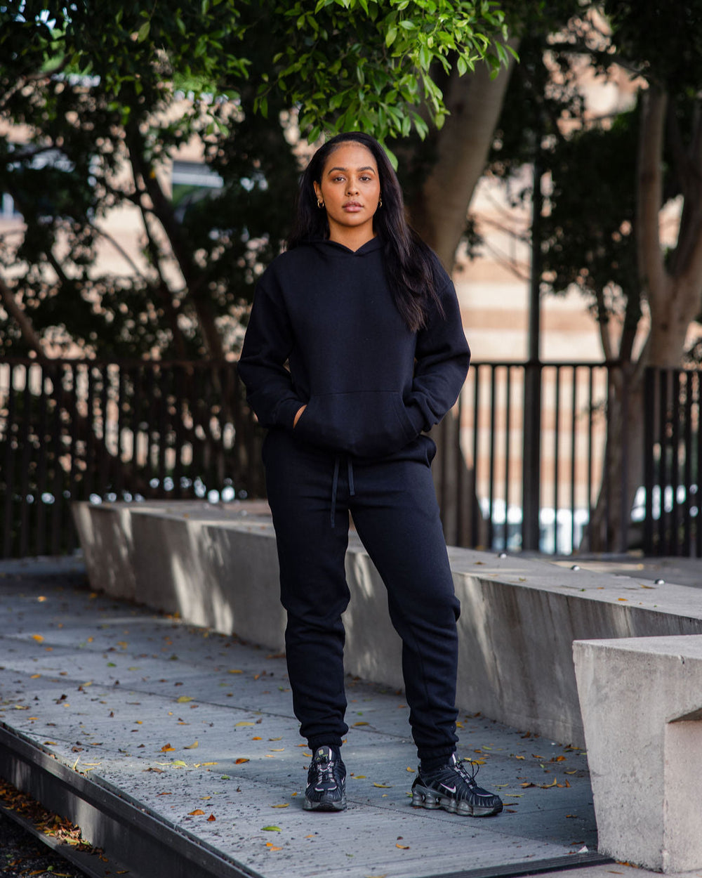 next image of Pullover Hoodie Tracksuit - Black : Female model wearing a Reflex Unisex Hooded Sweatshirt (full body pose) -black