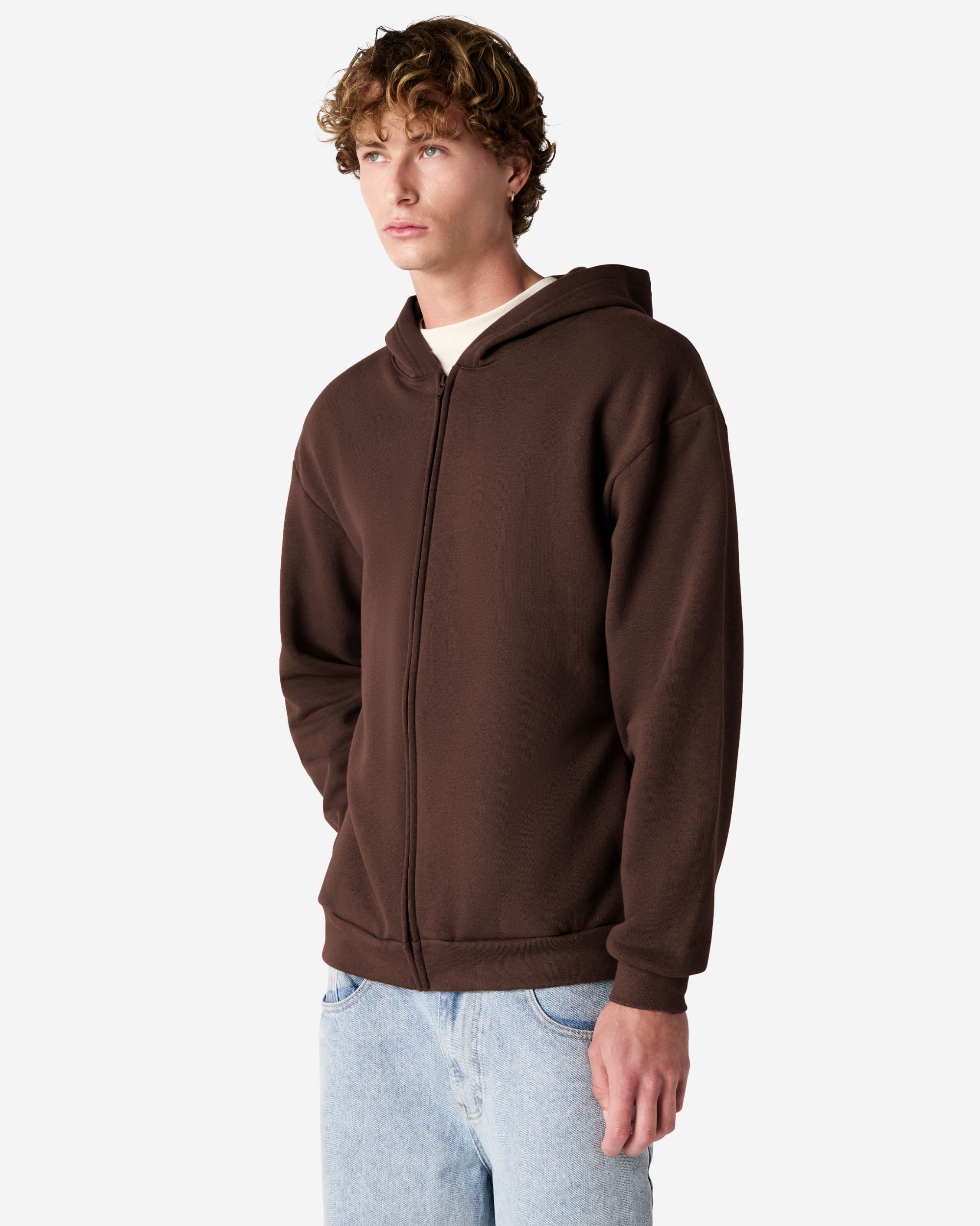 Male model wearing Reflex Unisex Full Zip Hooded Sweatshirt pairing with blue jeans (side front pose) -brown