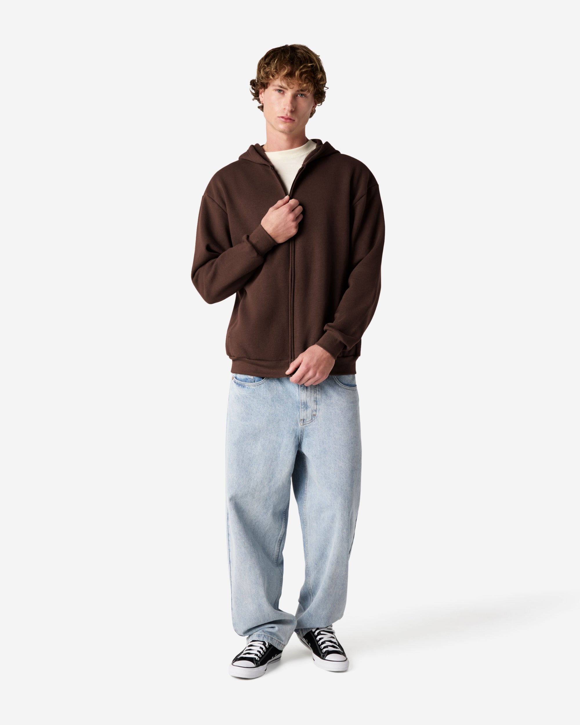 Male model wearing Reflex Unisex Full Zip Hooded Sweatshirt pairing with blue jeans (side front pose) -brown