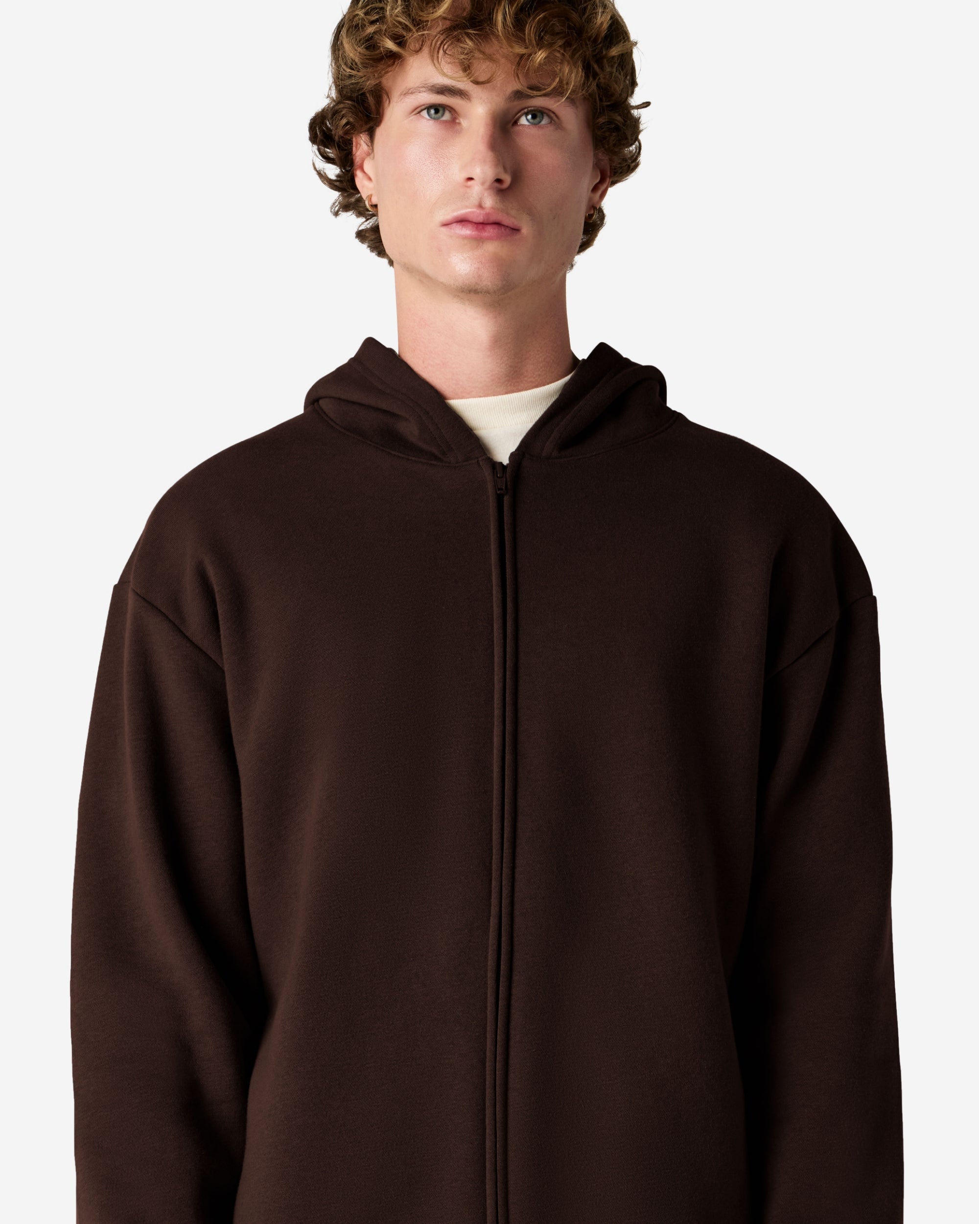 Male model wearing Reflex Unisex Full Zip Hooded Sweatshirt pairing with blue jeans (side front pose) -brown