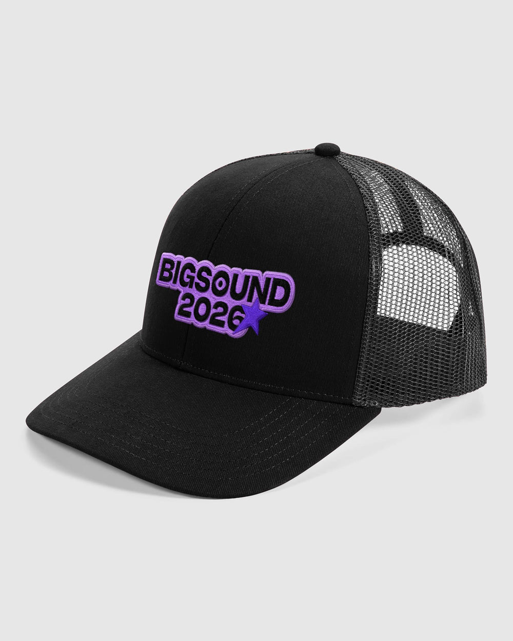 image of BIGSOUND Trucker Cap : A black trucker style cap with a curved brim, black mesh back panels, and a purple embroidered logo reading 'BIGSOUND 2026' on the front, shown on a light gray background -black
